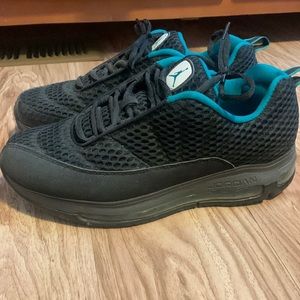 Jordan’s, black with teal and sparkly black accents. Men’s size 9.5
